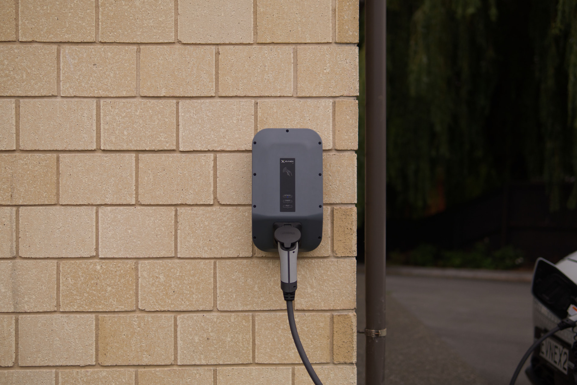 EV charge point mounted on an external brick wall