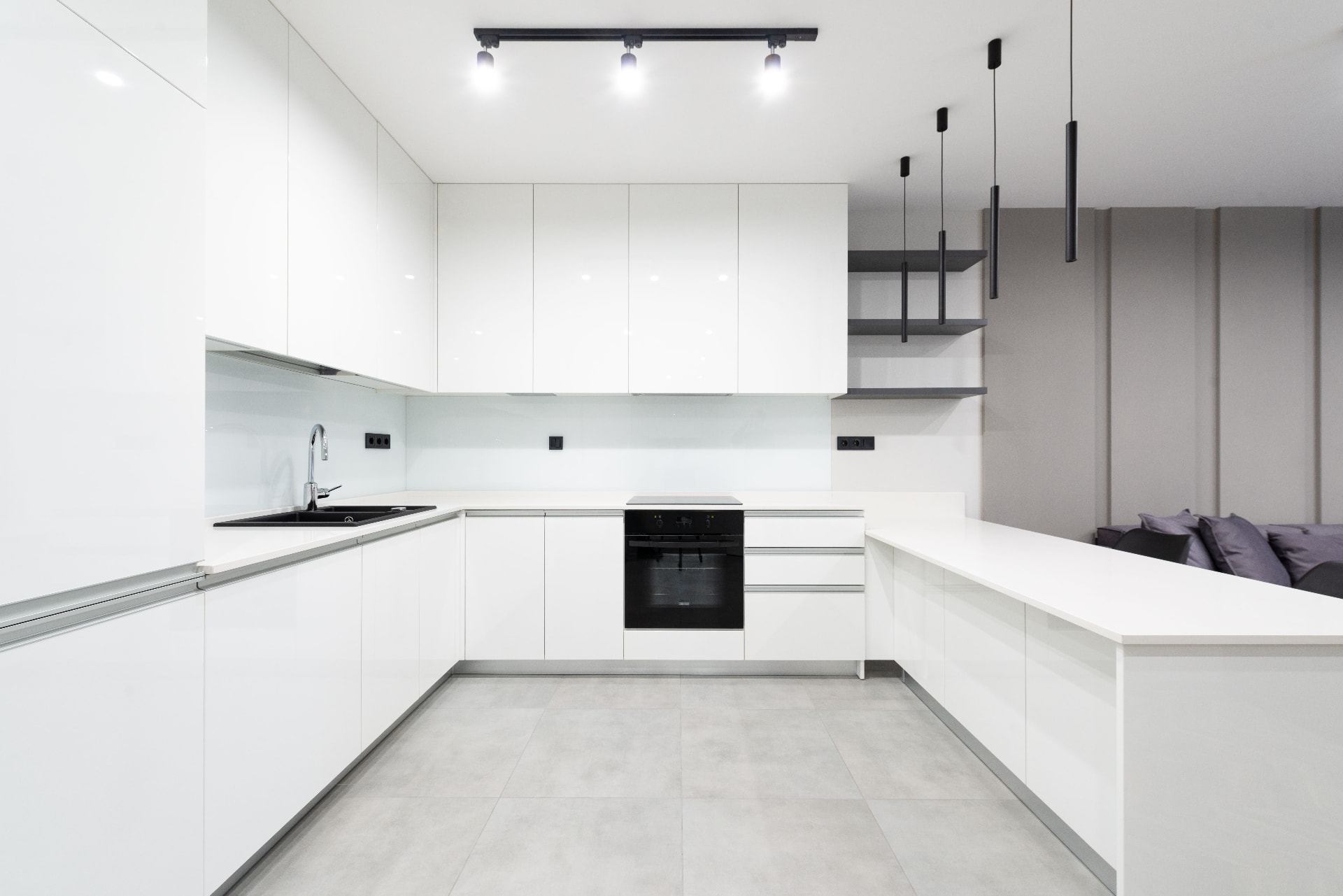 Modern white kitchen with integrated lighting and sockets